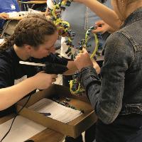 Students in previous Science Olympiad state tournaments work in teams to solve problems, build devices and learn more about STEM areas. 