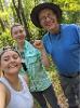 Photo of students smiling and holding an artifact
