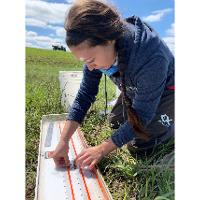 Krista Ward measures the standard length of a green sunfish at Youngmeyer Ranch in 2020.
