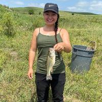 Krista Ward holds the 1000th green sunfish she sampled at Youngmeyer Ranch.