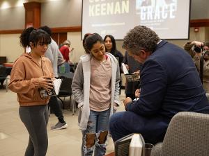 Keenan signs books for students following the student leader event