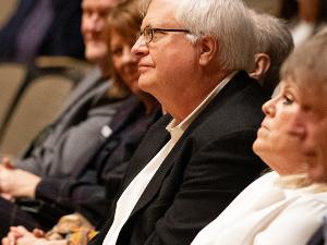 Barton Speaker Series sponsor Craig Barton listens to Cody Keenan's speech.