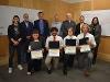 Holding their certificates, the Optimum Wellness team poses with the final round judges.