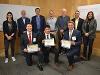 Holding their certificates, the Vision Vest team poses with the judges of the final round.