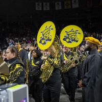 Several band members playing their instruments as they started the commencement ceremony with Wichita State University's fight song.