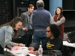One group is engaged in conversation, while another group is busy building something.