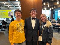 Three students pose in Club 95 on Wichita State's campus.