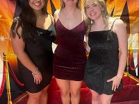 Three Gore Scholars pose in formalwear at an event.