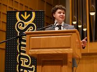 A student speaks at a podium.
