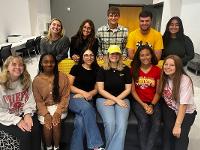 Gore Scholars pose for an informal group photo in the atrium of the Marcus Welcome Center.