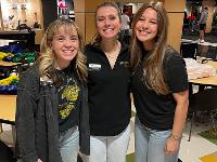 Three Gore Scholars post for a photo in Shocker Sports Grill and Lanes at the Rhatigan Student Center.