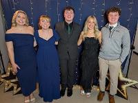 A group of students in formalwear pose for a photo.