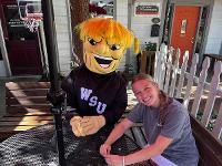 A student seated at a picnic table with WuShock.
