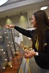 A volunteer assembles the decoration in Devlin Hall's Lobby