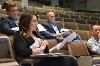 A judge uses her notes to gesture as she asks a question