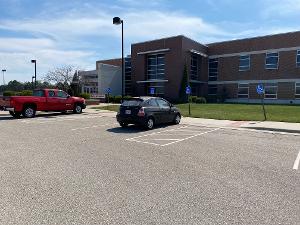 Photo of ADA parking spaces in front of the entrance to the AEGD building. 