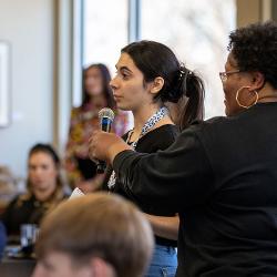 A student asks a question at the Barton Speakers Series Student Event.