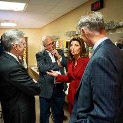 O'Donnell speaks with Craig Barton, WSU President Rick Muma, and WSU First Gentleman Rick Case.