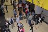 Judges mill about speaking to competitors from five different booths. At one, people interact with a CPR dummy.