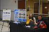 Adam Key and Shelby Partridge pose with their team's booth.