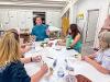 Brookelle Peterson lecturing at a table with instructors.