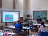 Robert Bubp lecturing beside a projector screen.