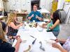 Brookelle Peterson seated at a table with instructors.