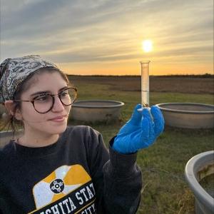 Student  holding vial.