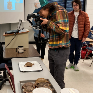 Student taking picture of specimen