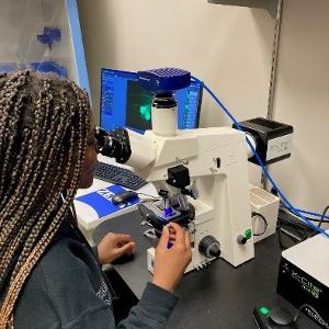 Girl looking into microscope