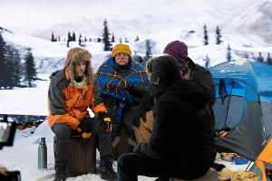Actors on a snowy set in front of the LED volume.