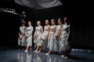 Dance students in a pool of water.