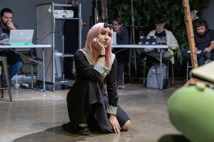 A cosplayer in Chika from Love is War costume for the figure drawing class.
