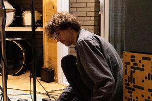 A student works on connecting wires for a recording session.