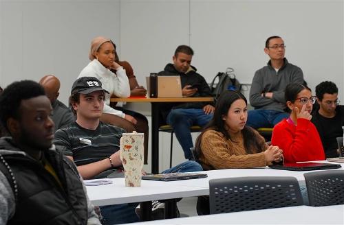 Teams listening to stand-up presentations.
