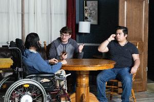 Three students acting on the sitcom set.