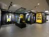 Exhibit area inside the Milly Marcus Annex featuring digital displays, a WuShock mascot head in a glass case, and graphics promoting applied learning and “Shock the World.”