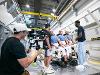 A film crew captures footage of a crash test dummy setup in a high-tech lab at Wichita State University.