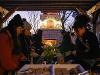 Students grab food at the new outdoor fireplace and pergola at the President's Residence. Students are dressed up in warm clothing for the winter weather.