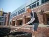 First Gentleman Rick Case tends to a raised garden bed at Wichita State University's community garden on a sunny day.