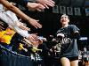 A player for Shocker volleyball high fives fans after the team won the American Athletic Conference Championship.