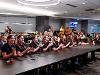 The Shocker women's bowling team awaits to see how they are seeded in the NCAA championship. The team and guests are in attendance in a classroom-styled space.