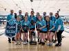 The Shocker women's bowling team pose in a bowling alley with their trophies and banner after winning the CUSA Championship. The team are all in light blue CUSA Championship shirts.