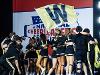 The Shocker cheer team wave a yellow flag with a "W" on it.