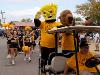 WuShock and Ike parade around the Kansas State Fair on a golf cart followed by Shocker cheer.