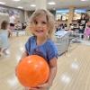 child holding a bowling ball