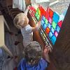 children playing with tiles on window 