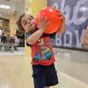child holding a bowling ball