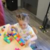 child playing with blocks at a table