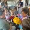 children looking at a hat 
